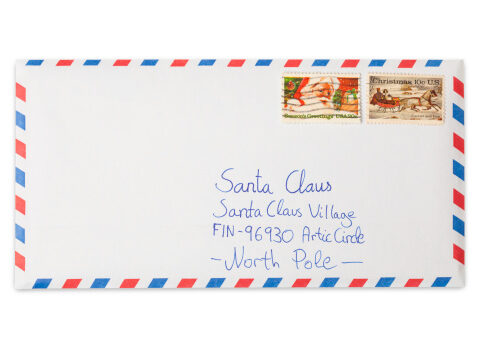 Letter to Santa Claus with his address written on it in a air mail envelope isolated on white background. Franked US Christmas stamps on it. This is an exclusive image and it can only be found in iStockphoto.
